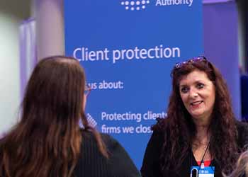 Image of professional women in front of client protection banner